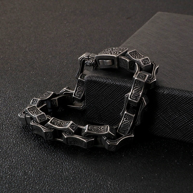 Men's vintage engraving square bracelet in punk style, showcasing intricate designs and a unique shape on a dark surface.