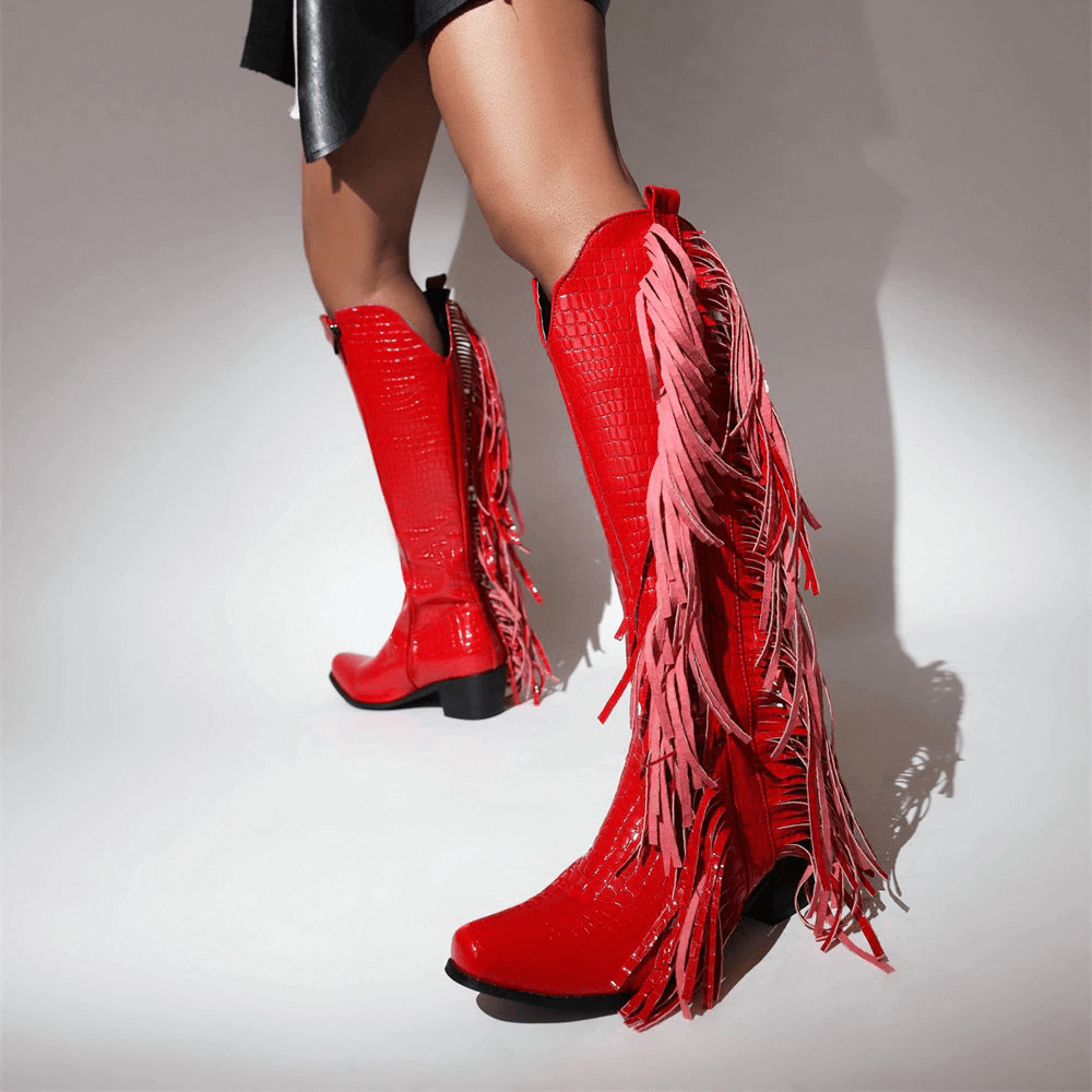 Red fringed vintage boots with tassels, stylish knee-high alternative footwear for women.