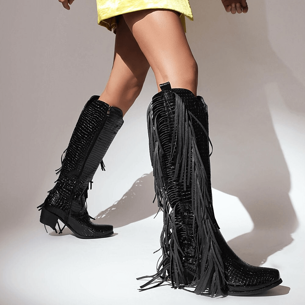 Stylish women's high knee vintage boots with fringes and tassels, perfect for an alternative fashion look.
