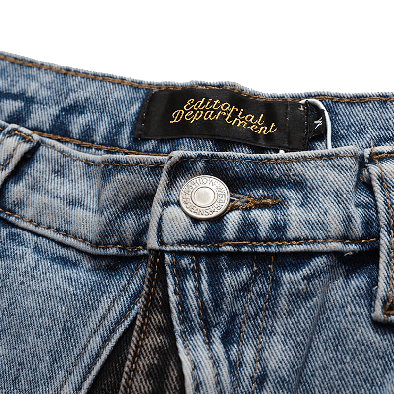 Close-up of men’s denim shorts waistband featuring patchwork design and stylish label for alternative fashion.
