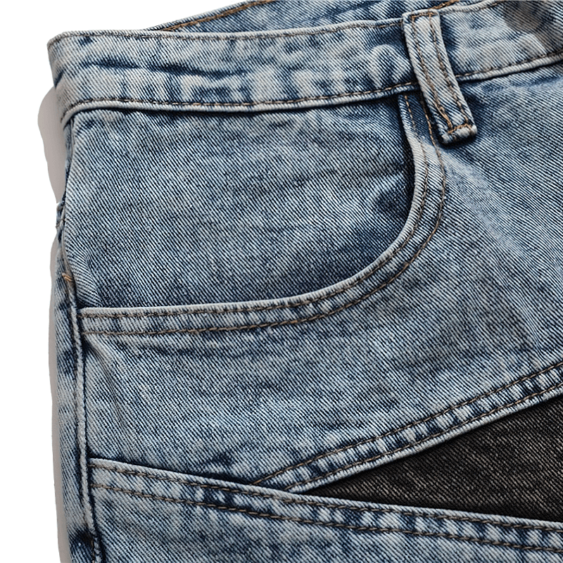Close-up of men's patchwork loose denim shorts showcasing stylish fabric details and unique design elements.