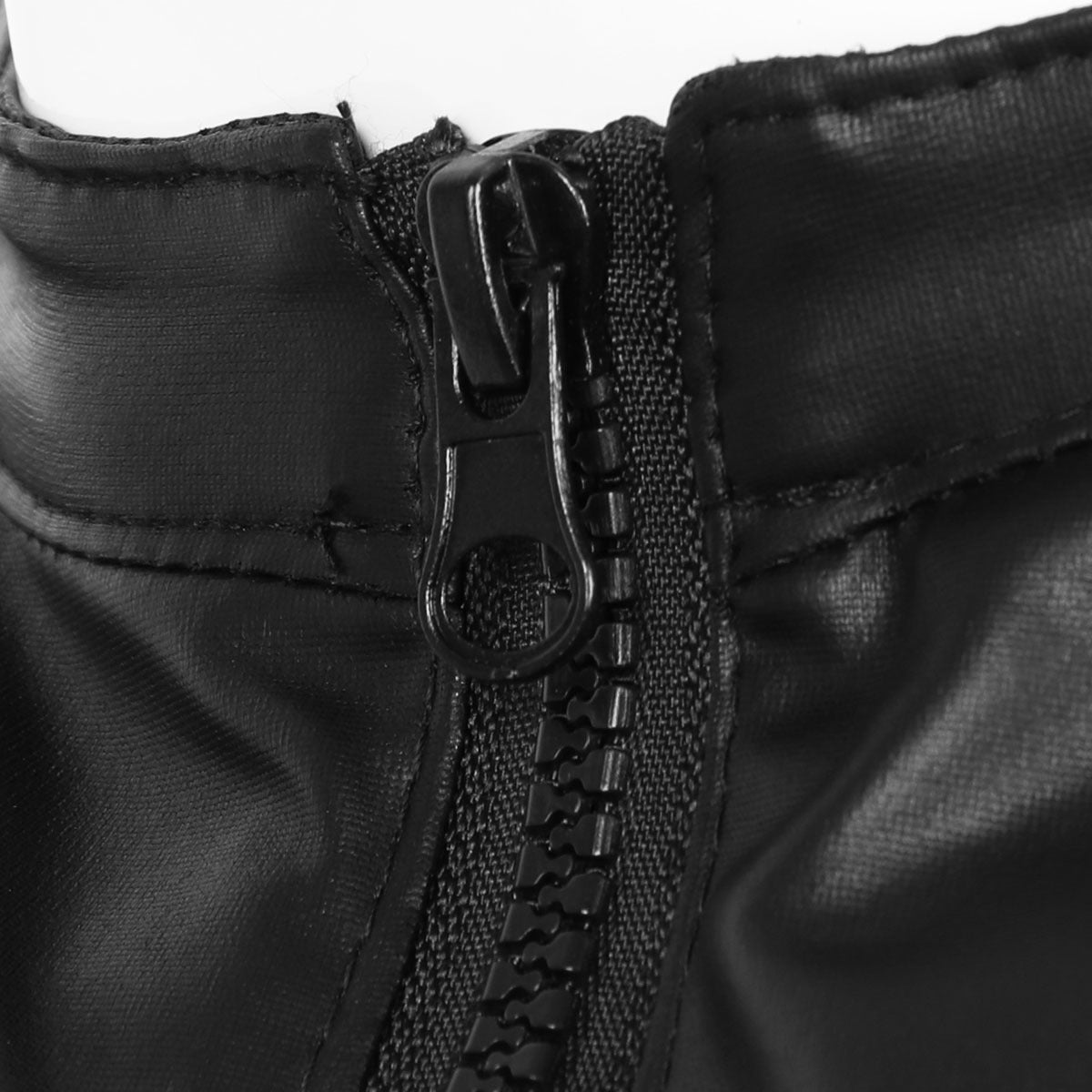 Close-up of black faux leather tank top zipper, showcasing trendy fashion for men, perfect for performances and parties.