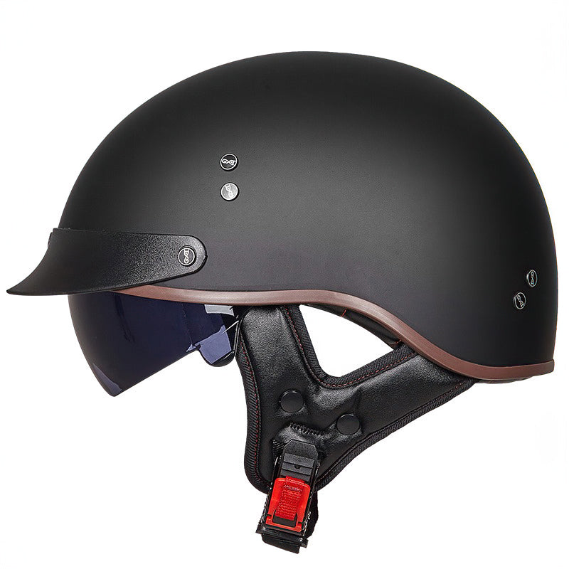 Full black vintage half face biker helmet with visor and chin strap for comfort and safety.