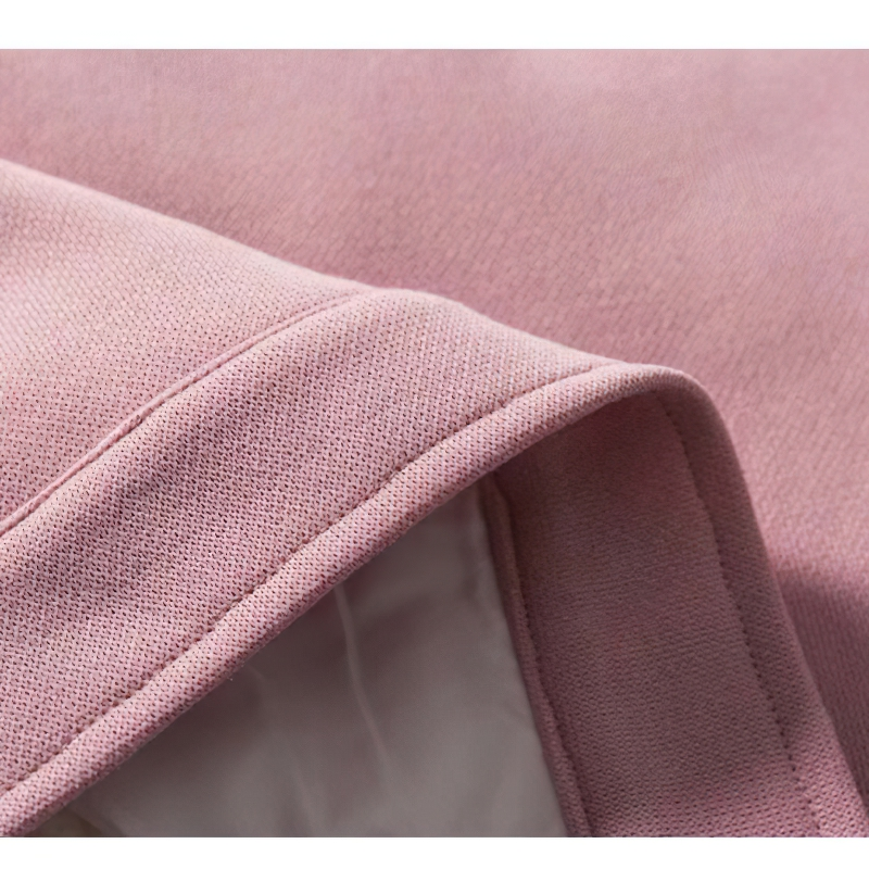 Close-up of the soft fabric and collar of a pink women's oversized jacket, showcasing its stylish patchwork design.