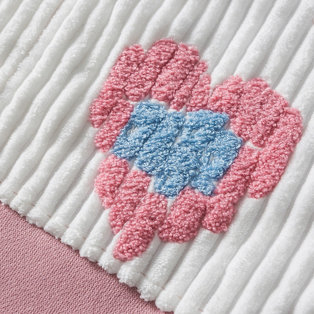 Colorful patchwork heart design on women's oversized jacket fabric, perfect for trendy casual wear.