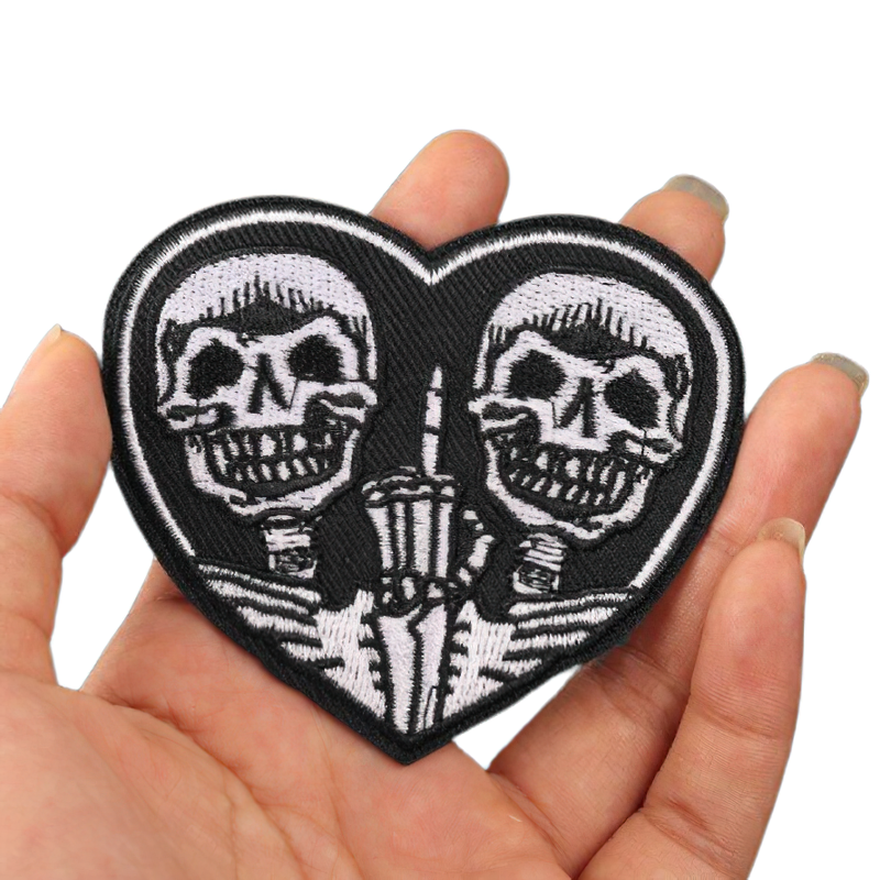 Heart-shaped patch featuring two skeleton designs, perfect for adding a rock style to jackets and clothing.