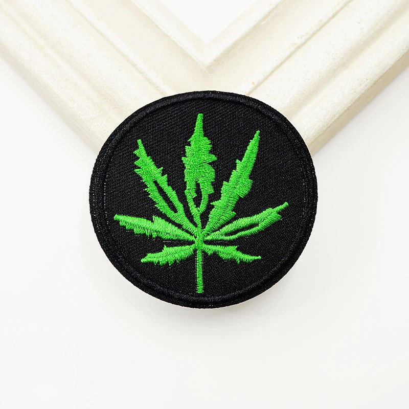 Green ganja leaf embroidered patch for trendy alternative fashion on clothes and accessories.