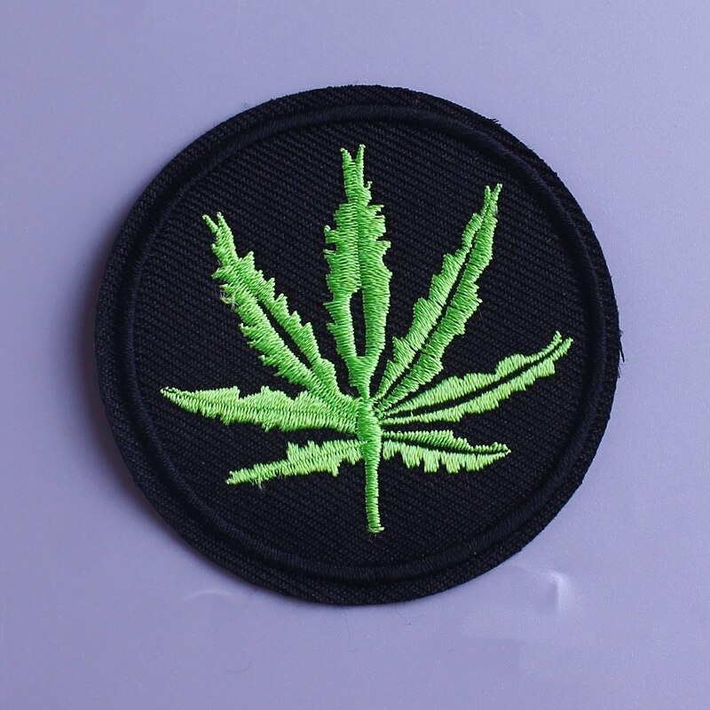 Ganja leaf print fusible patch on black background, perfect for alternative fashion on clothes and backpacks.
