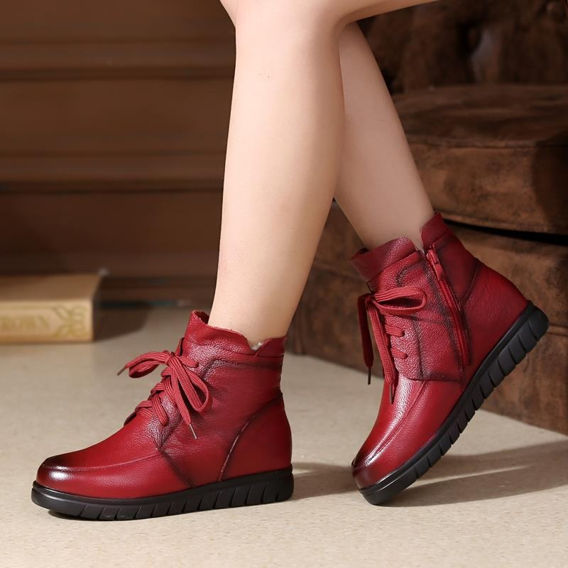 Stylish women's genuine leather ankle boots in red, featuring lace-up design and comfy flat sole.