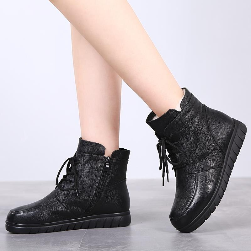 Stylish women's black leather ankle boots with lace-up design and a comfortable low sole, perfect for casual outings.
