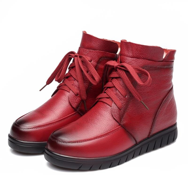 Genuine leather women's ankle boots in red, featuring a lace-up design and comfortable flat sole for casual wear.