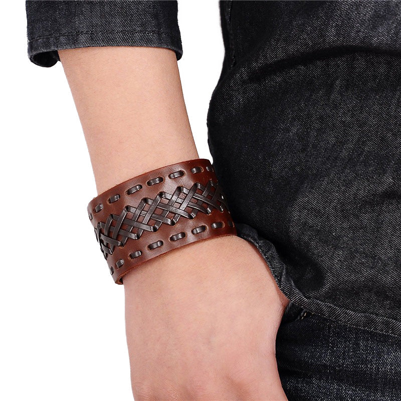 Handmade Viking-style leather bracelet with braided design, showcasing a wide cuff on a wrist.