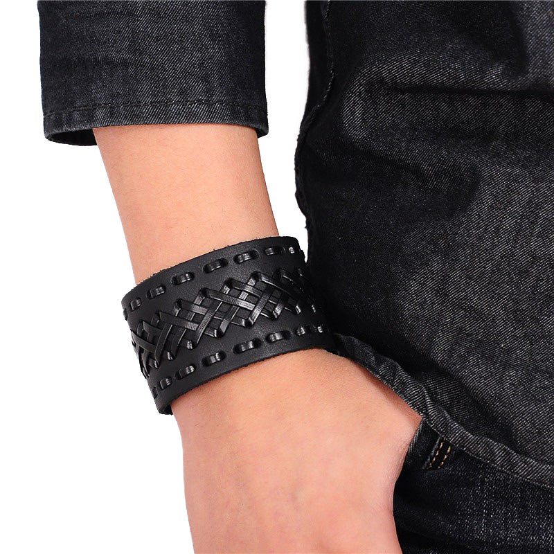 Black braided leather cuff bracelet on a wrist, stylish Viking-style accessory for men and women.