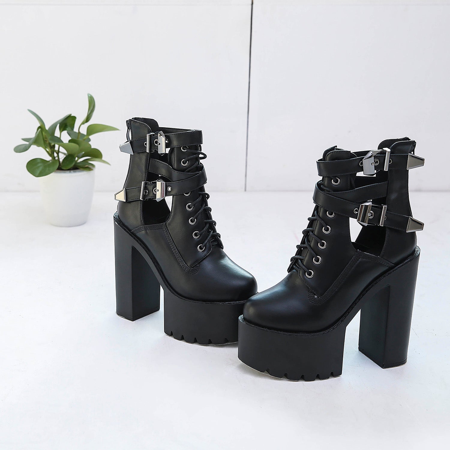 Genuine leather black platform ankle boots with metal buckles and laces, perfect for rocker outfits.