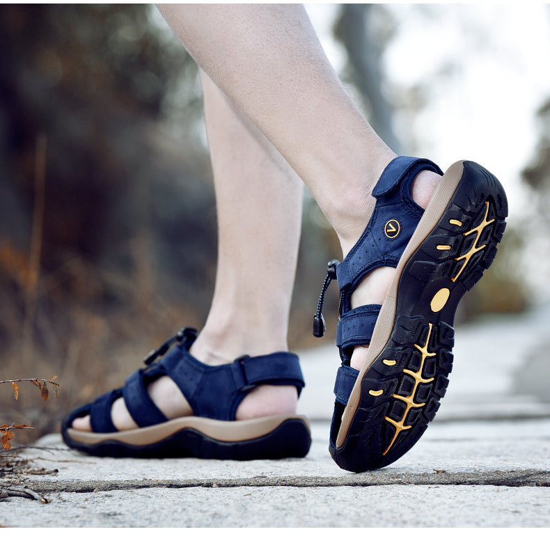 Male genuine leather sandals in navy blue shown on a foot, perfect for summer beach outings and casual outdoor adventures.
