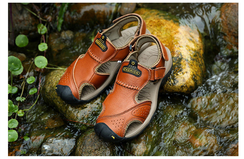 Comfortable men's genuine leather sandals for summer adventures, showcasing a stylish brown design on a rocky surface.