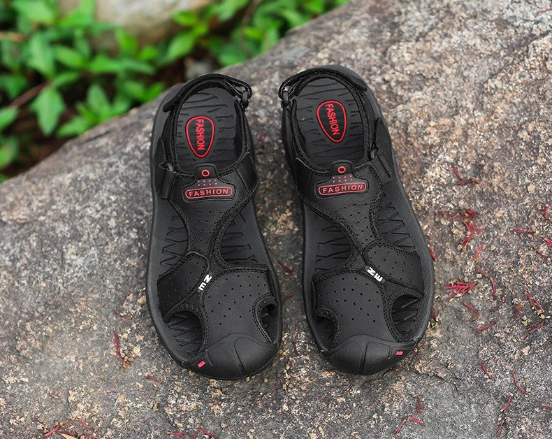 Men's black casual sandals on a rock, perfect for summer outdoor fashion and comfortable daily wear.