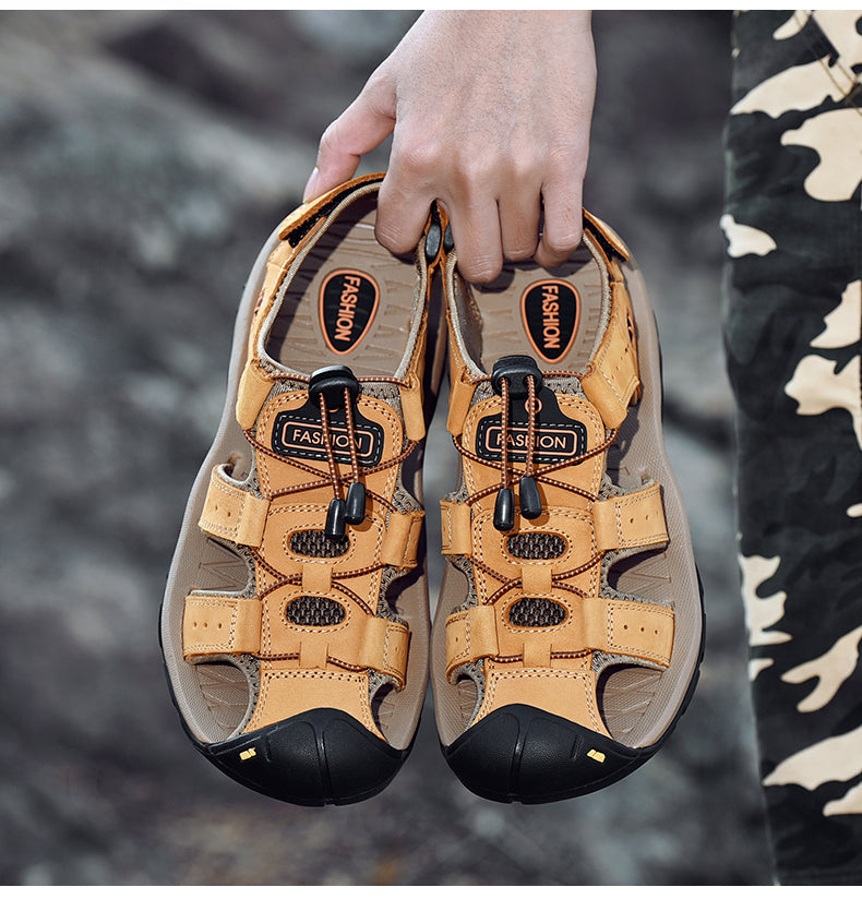 Male genuine leather sandals in hand, showcasing stylish design with buckle straps for summer outdoor fashion.