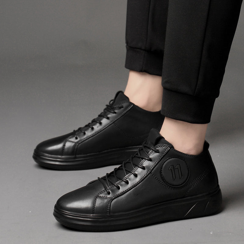 Genuine leather mid-top men's sneakers in sleek black, perfect for alternative fashion and rave outfits.