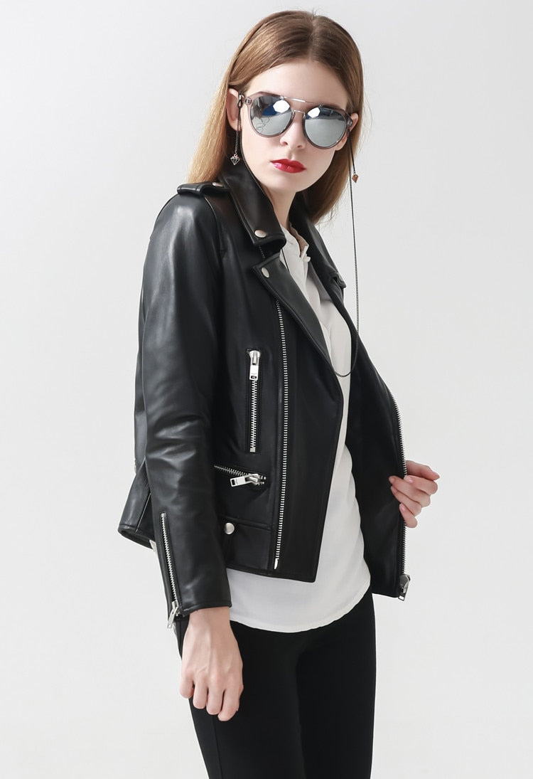 Stylish woman wearing a genuine leather motorcycle jacket, exuding rock style and confidence.