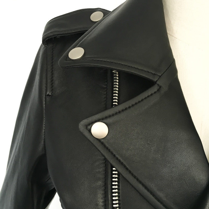 Close-up of a men's genuine leather motorcycle jacket featuring stylish zippers and bold buttons.