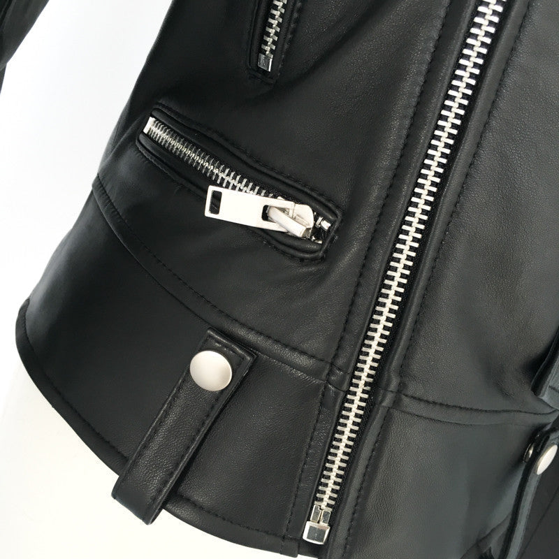 Close-up of a black genuine leather motorcycle jacket with zippers and adjustable straps, exuding rock style and audacity.