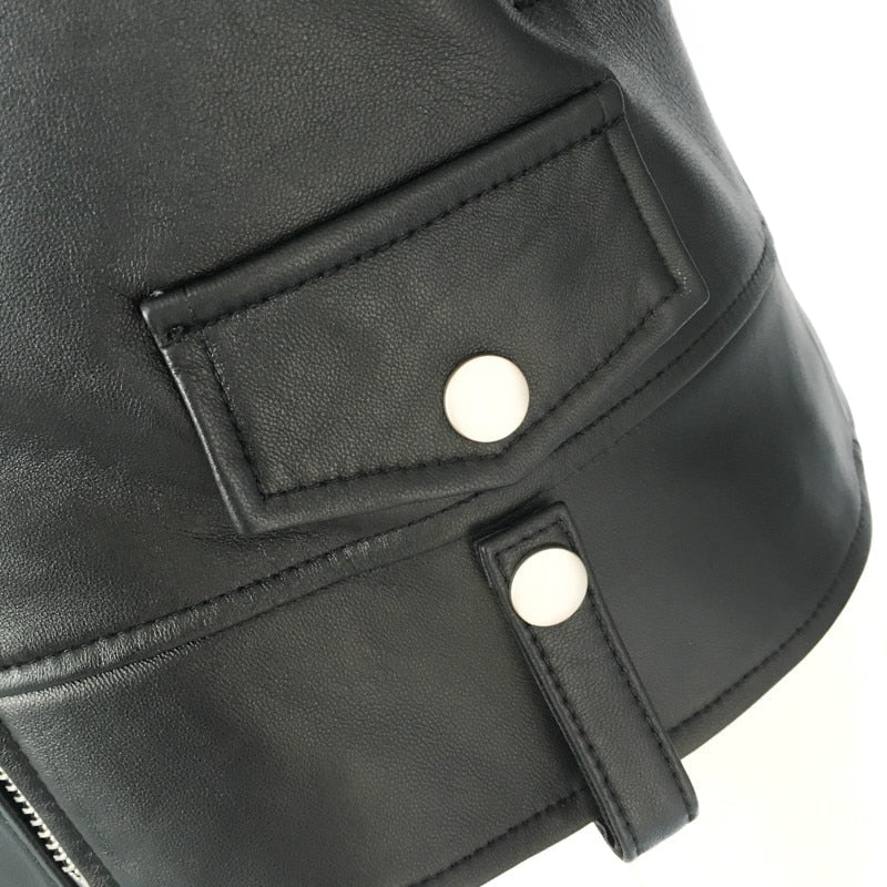 Close-up of genuine leather motorcycle jacket with pockets and snap buttons, showcasing its unique design and rock style.