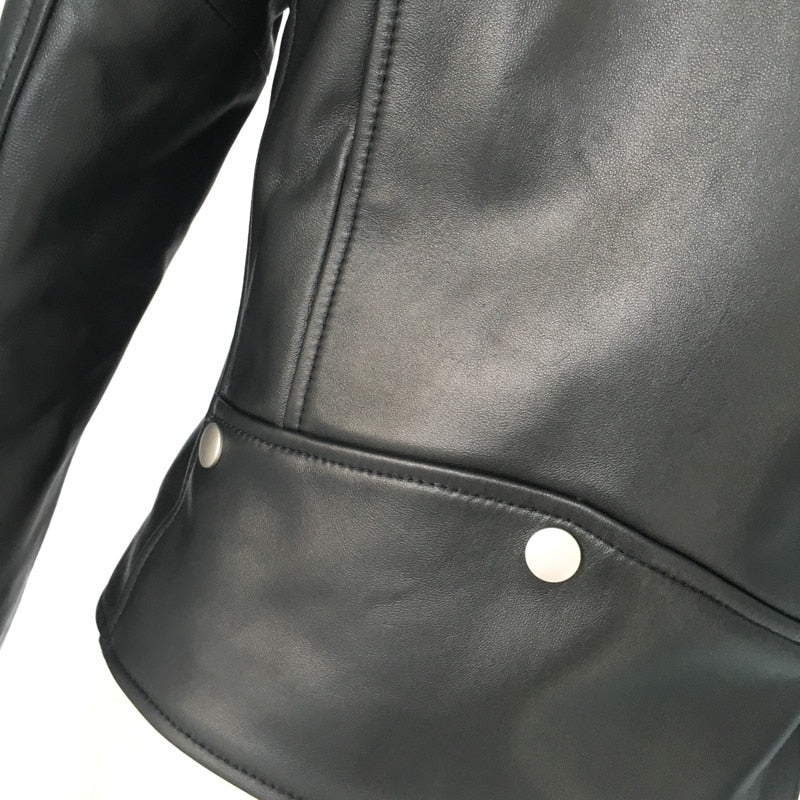 Close-up of the sleek design and silver snap buttons on a genuine leather motorcycle jacket.