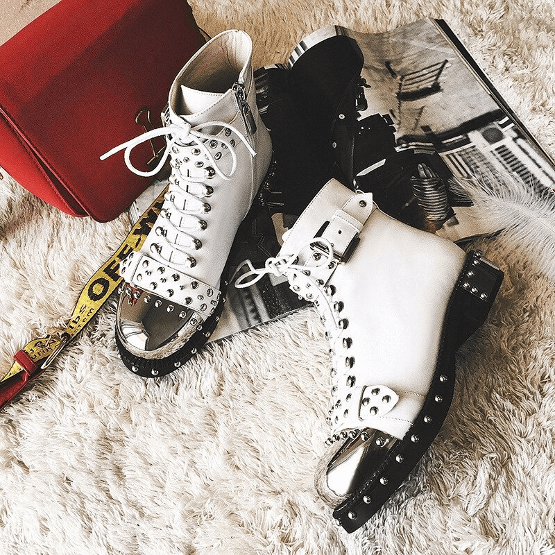 Genuine leather punk rock ankle boots with rivets and zippers, featuring a stylish flat sole and lace-up design.