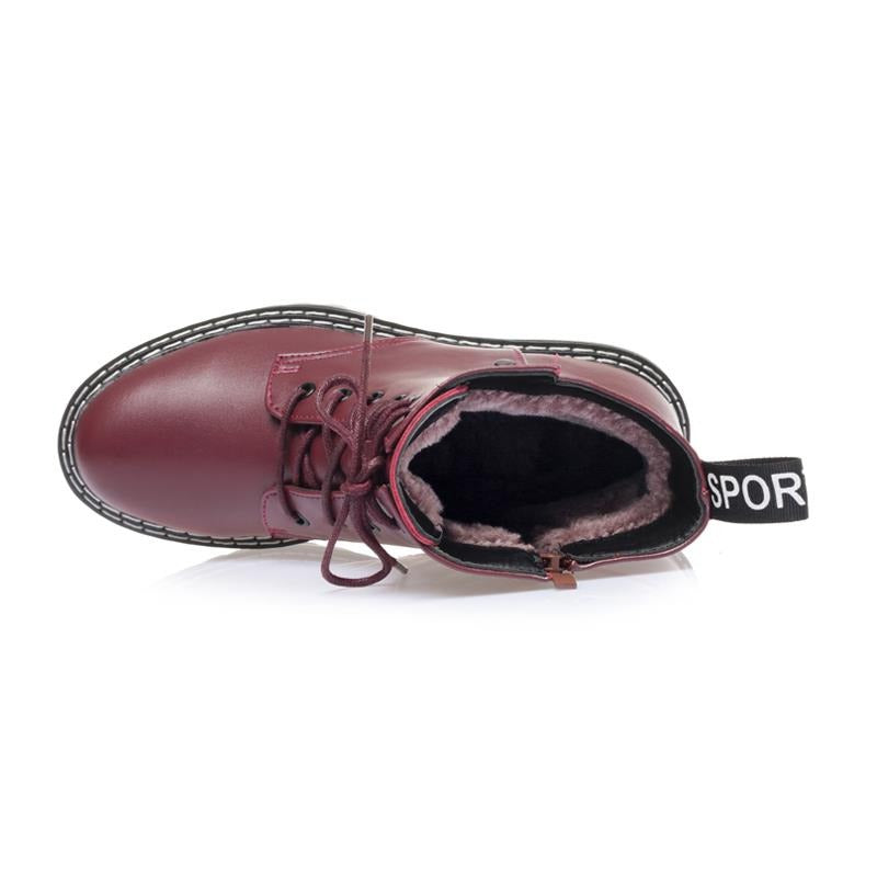 Top view of burgundy genuine leather snow ankle boots for women with warm wool lining and black rubber sole.