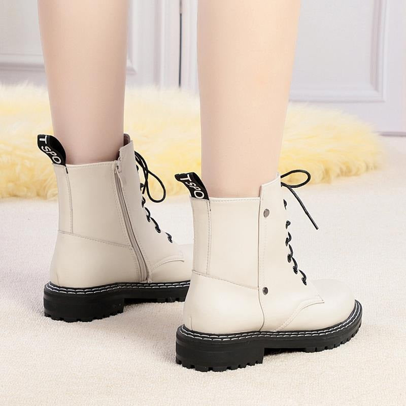 Genuine leather women's ankle boots in light grey with black chunky soles and stylish lace-up design.