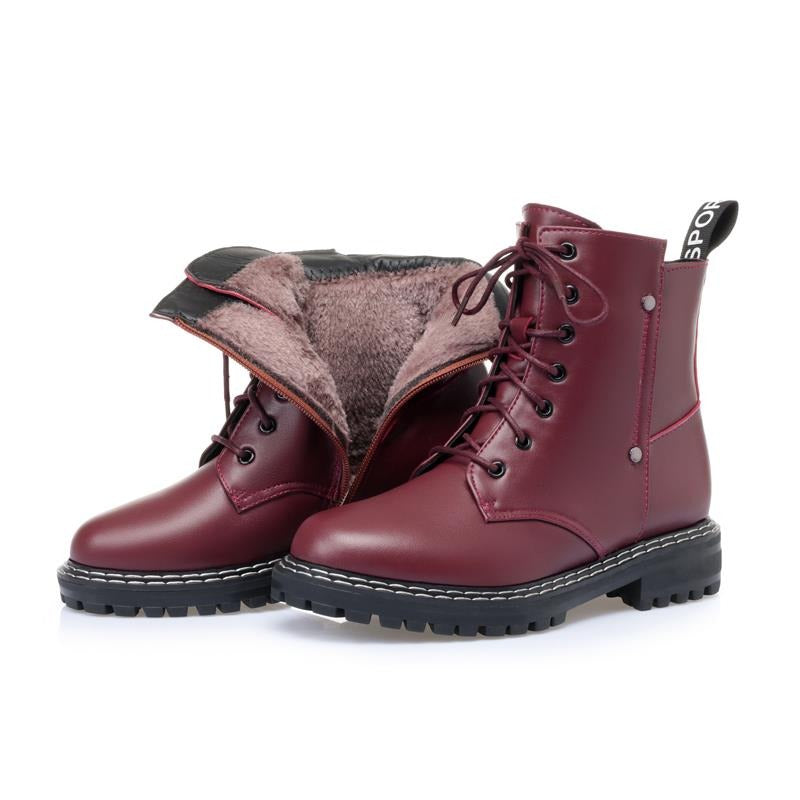 Genuine leather snow ankle boots for women in burgundy with warm wool lining and chunky rubber sole.