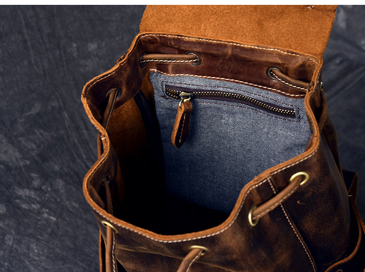 Inside view of a genuine leather travel backpack with a zip pocket and soft lining, perfect for rock and steampunk fashion.