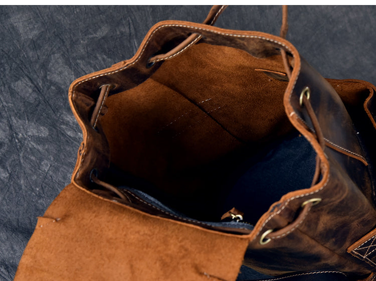 Interior view of a genuine leather travel backpack, featuring suede lining and roomy compartment for storage.