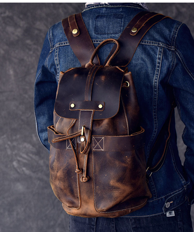 Genuine leather travel backpack in rock style, featuring straps and pockets, perfect for goth outfits.