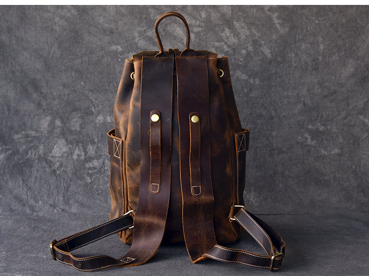 Back view of a genuine leather travel backpack with stylish straps, perfect for rock and steampunk fashion.