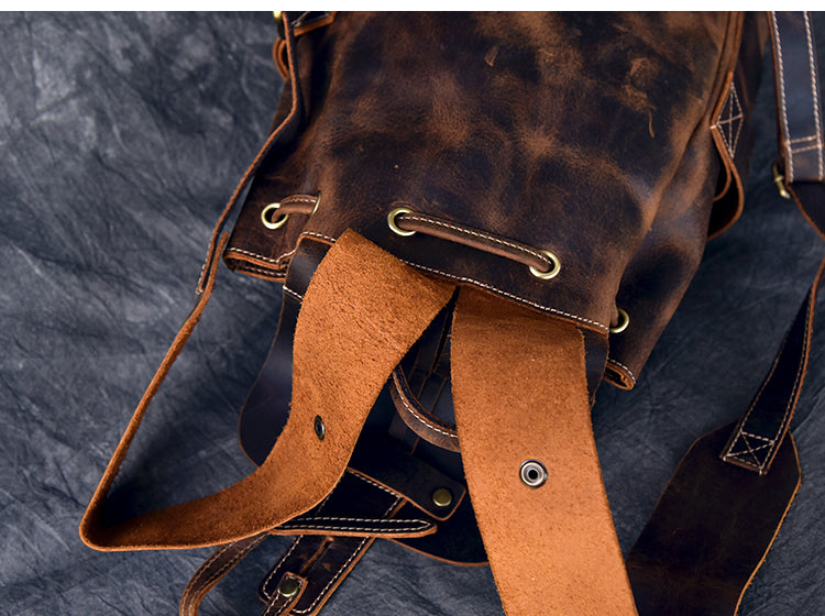 Close-up of a genuine leather travel backpack with stylish straps and a rugged design, perfect for rock and steampunk aesthetics.