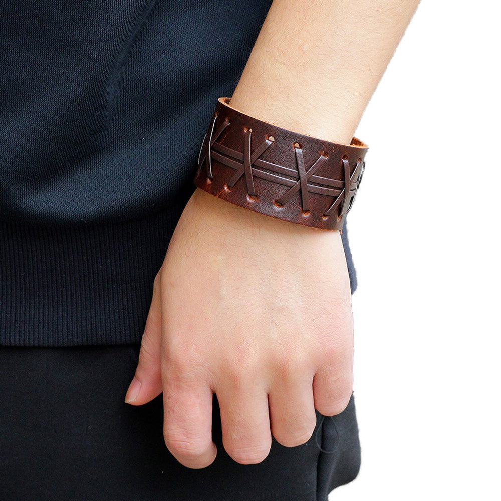 Stylish genuine leather wide bracelet in brown on wrist, showcasing a rock style design with easy-hook clasp.