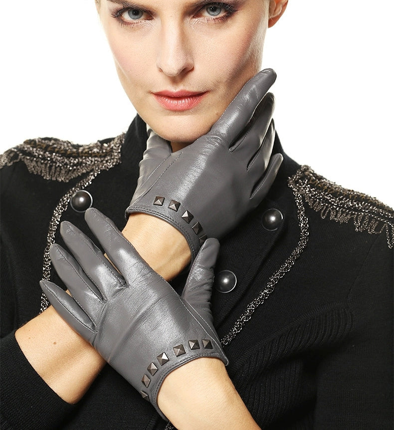 Stylish women's genuine leather gloves in gray with wrist rivets, perfect for alternative fashion and festivals.