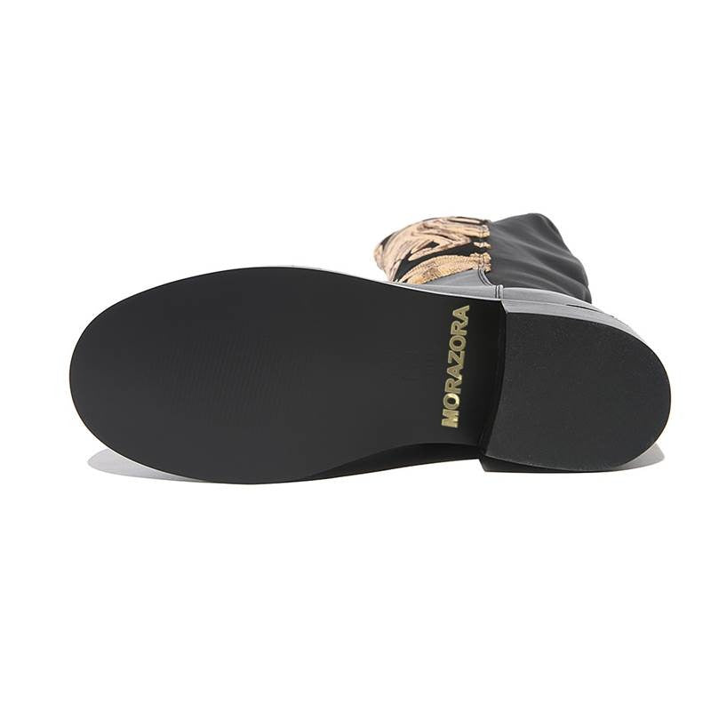 Sole view of genuine leather women's knee-high boots with stylish golden sequins and alternative fashion design.