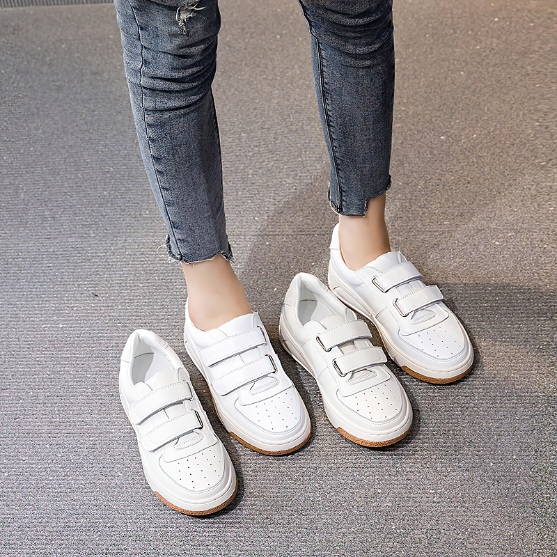 Stylish genuine leather women's sneakers in white with cross ties, perfect for spring or fall outfits.