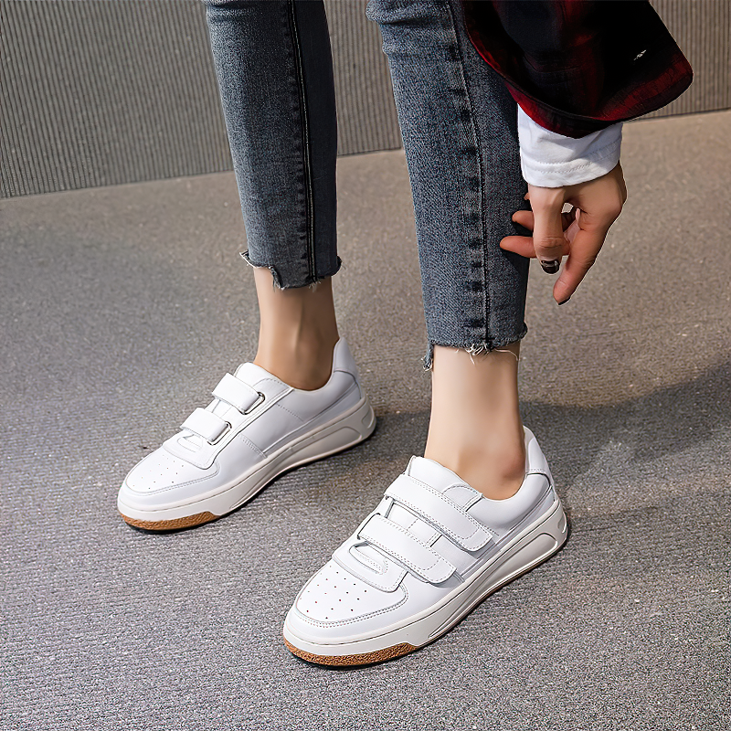 Genuine leather white women's sneakers with cross tie design, perfect for casual spring and fall outfits.