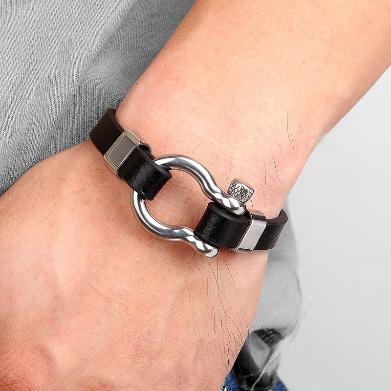 Stylish geometric circle toggle-clasp leather bracelet on wrist, combining stainless steel and rock style elegance.