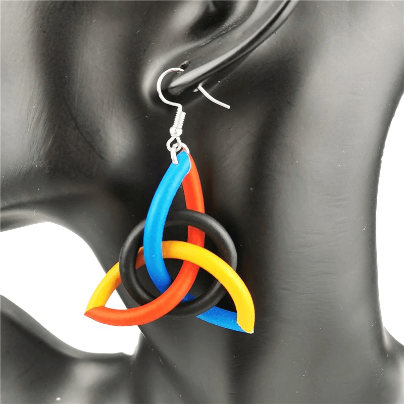 Handmade geometric multicolor rubber earrings showcasing vibrant orange, blue, black and yellow design, perfect ethnic accessory.