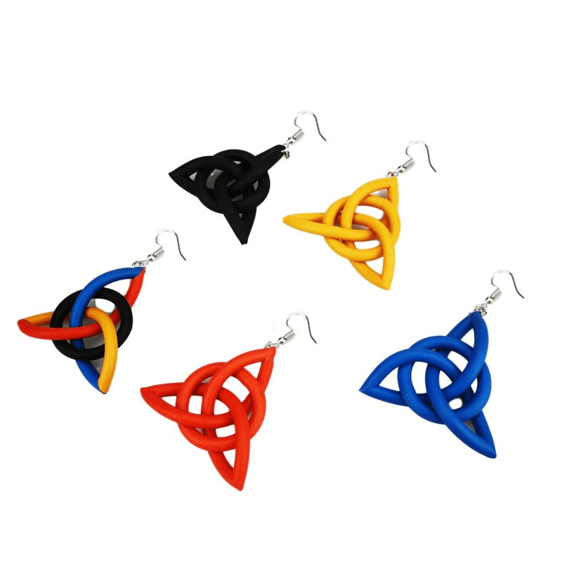 Colorful geometric drop earrings made of rubber, featuring unique handmade ethnic designs in black, yellow, red, and blue.