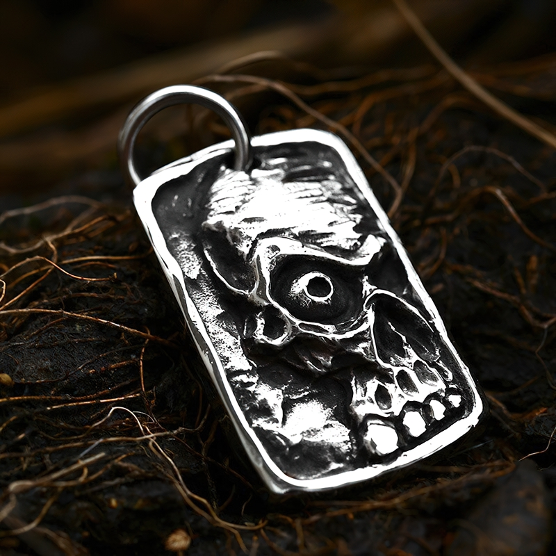 Unisex stainless steel ghost skull pendant, gothic fashion jewelry on a dark background.