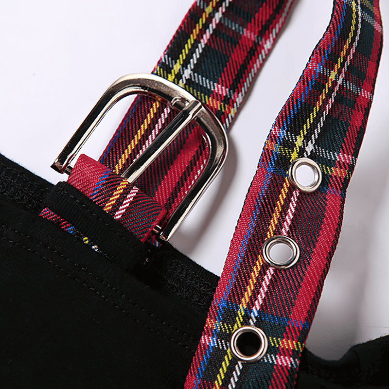 Detail of goth patchwork one-shoulder T-shirt featuring plaid straps and a silver buckle accent.