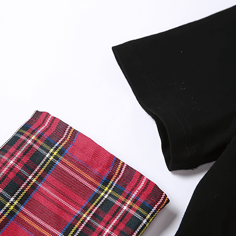 Close-up of Goth style patchwork t-shirt featuring black fabric and plaid sleeve design. Perfect for grunge fans!