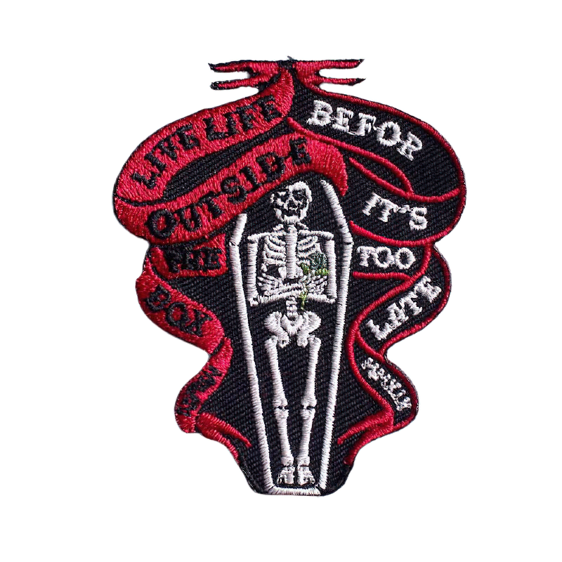 Gothic skeleton in coffin patch, stylish unisex accessory for clothing with motivational text.