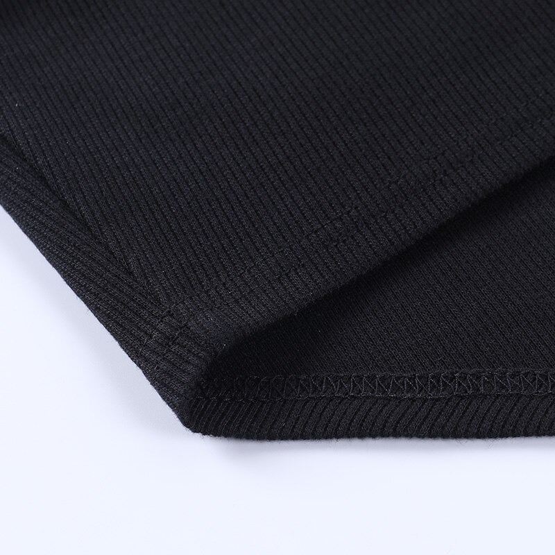 Close-up of the black fabric of a goth asymmetrical tank top showing its ribbed texture and clean stitching.